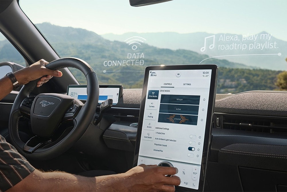 Een close-up van de bestuurder van een Ford Mustang Mach-E in interactie met het grote 15,5” SYNC 4 touchscreen