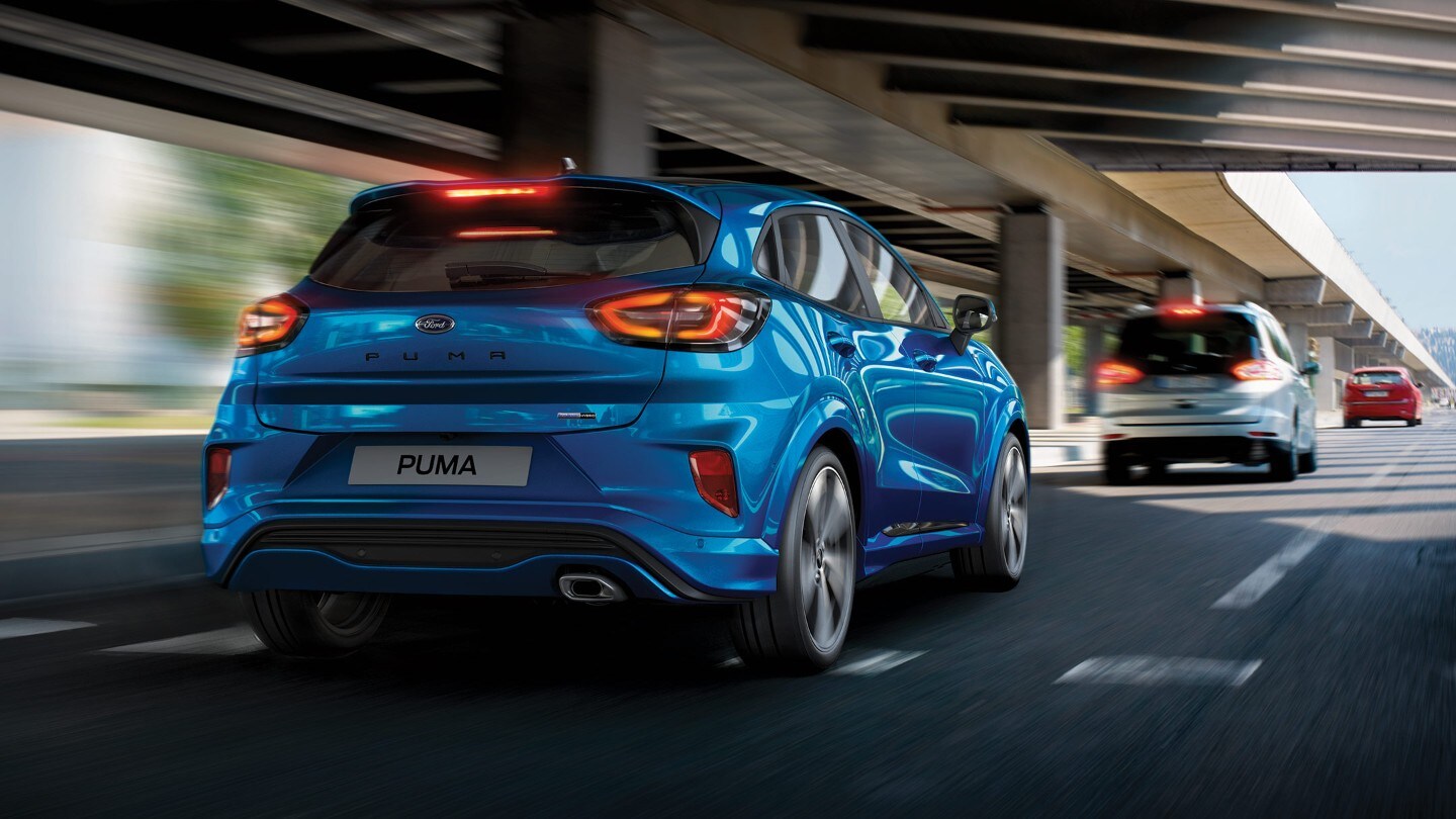 Blue Ford Puma driving in city