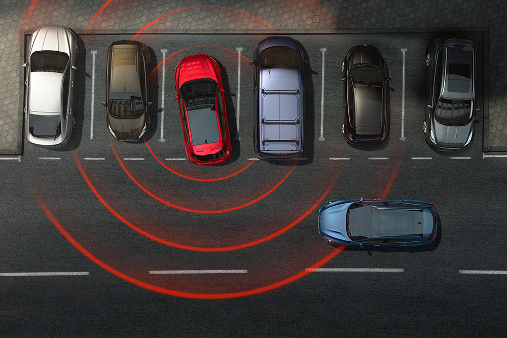 Graphique montrant une voiture Ford sortant en marche arrière d'une place de stationnement, avec l'alerte de trafic transversal activée.