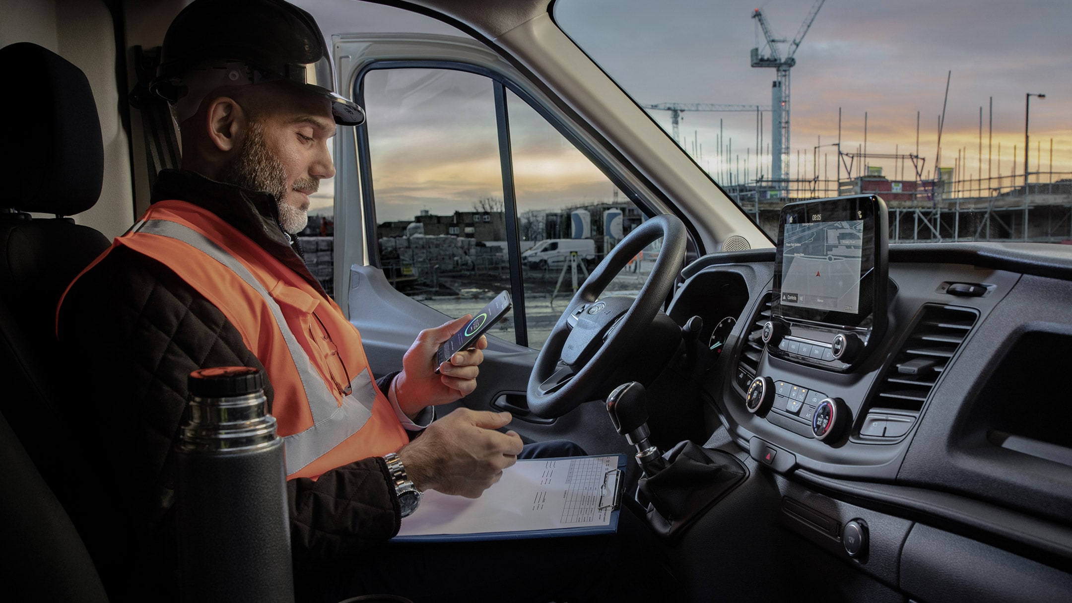 A worker in Transit Connect interior