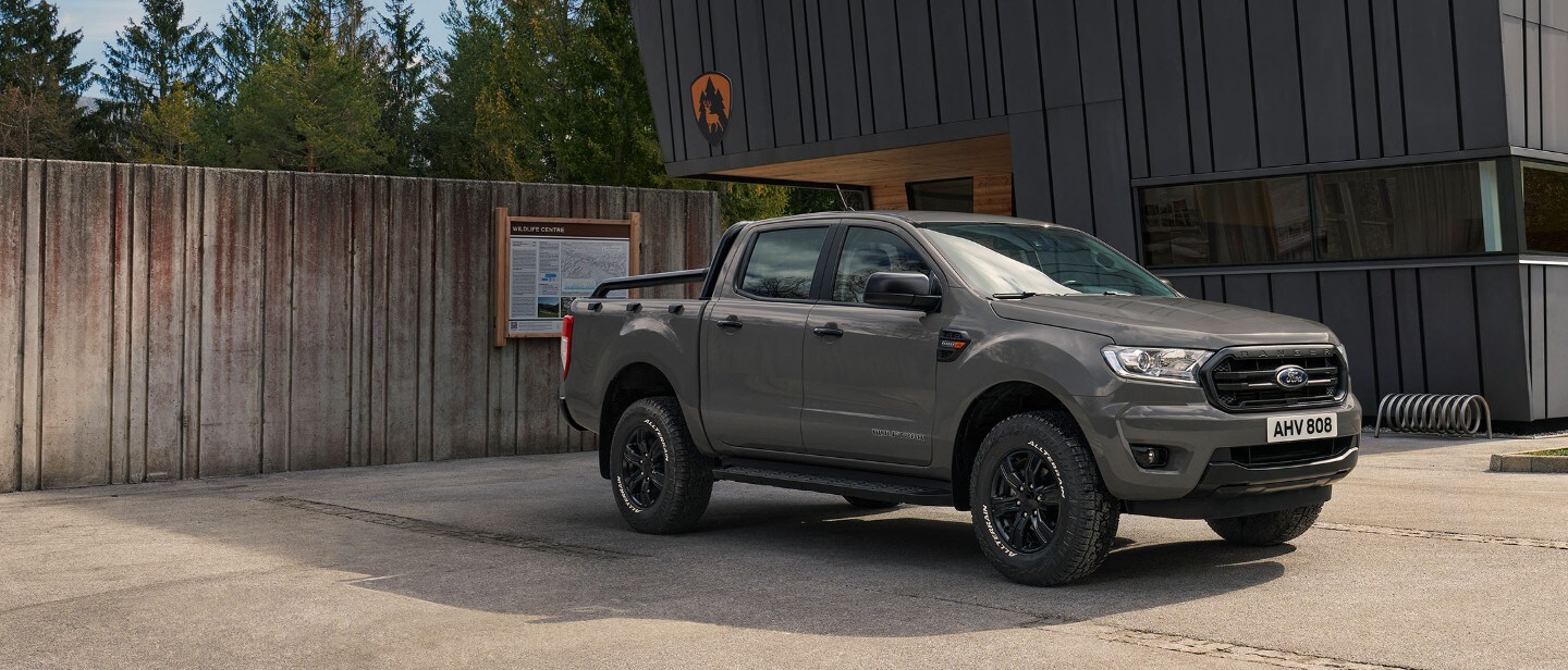 Grey Ford Ranger Wolftrak parked in front of a building Grey Ford Ranger Wolftrak parked in front of a building