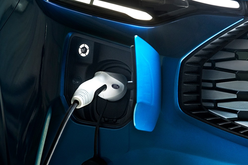 Un Ford Transit Custom bleu Plug-in Hybrid en train de charger.