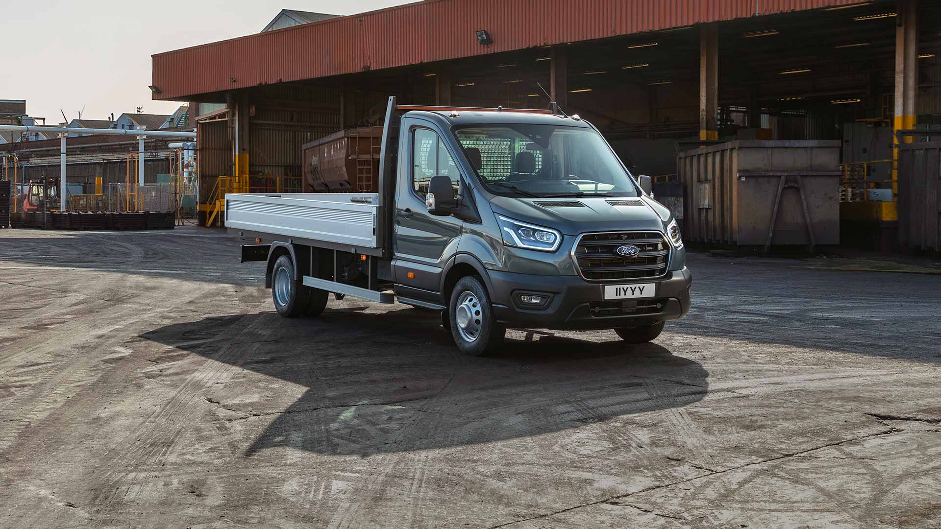 Ford Transit châssis-cabine stationné dans une zone industrielle.