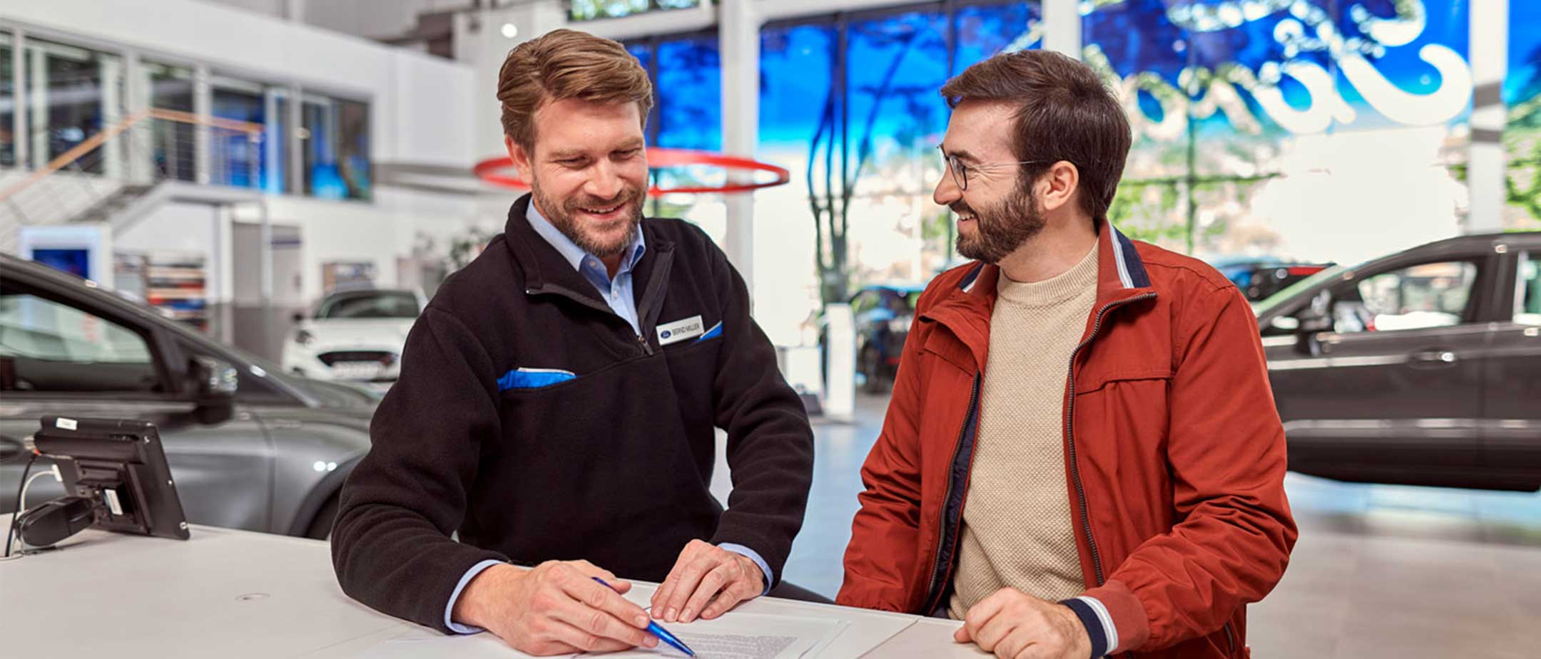 Man with dog booking a ford service