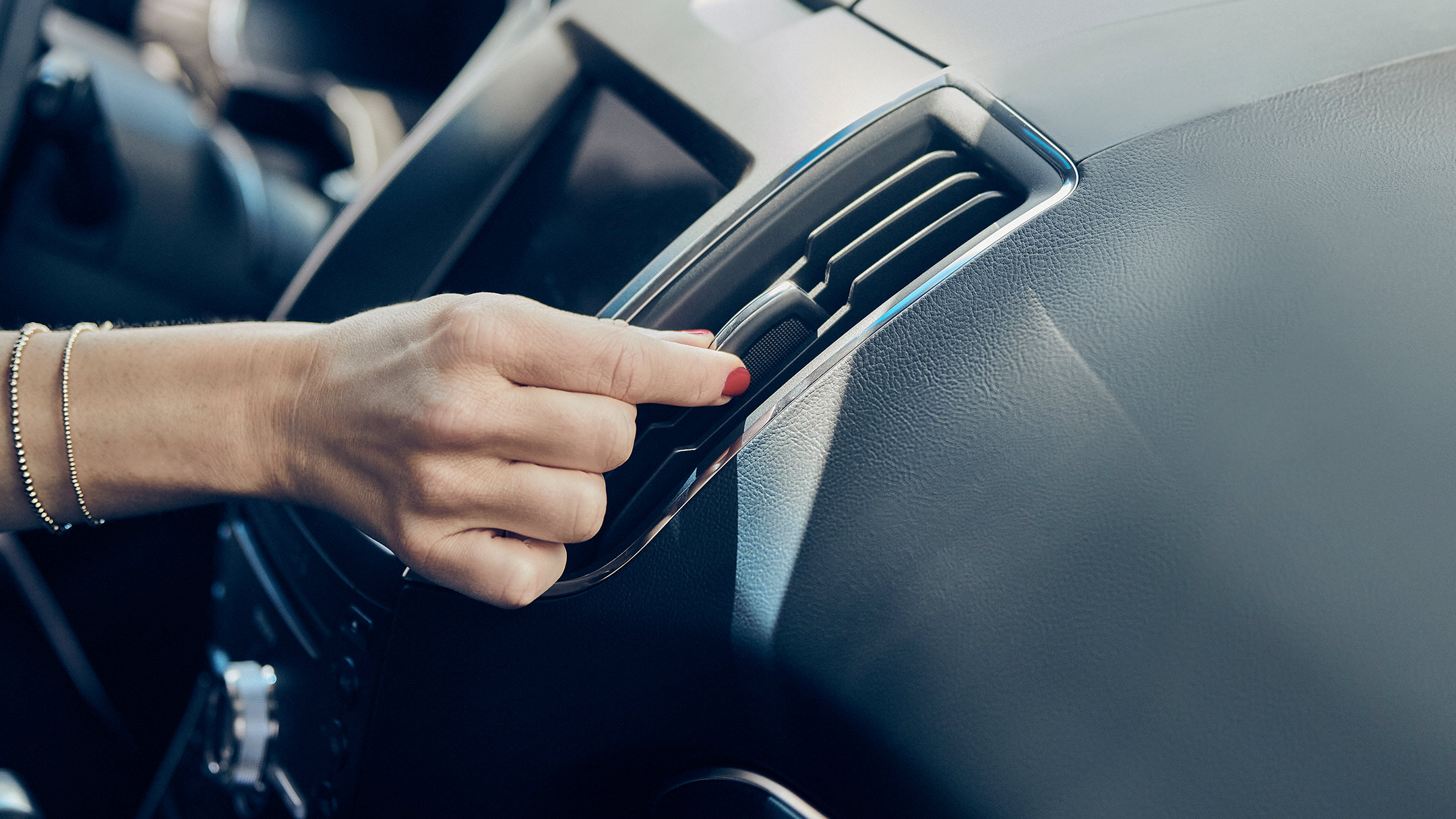 Hand adjusting ventilation in car
